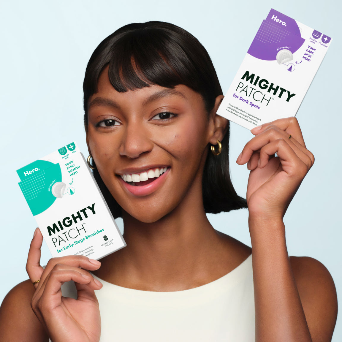 Model holding Hero Cosmetics Mighty Patch Micropoint products
